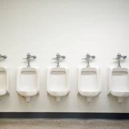 A row of urinals in a bathroom.