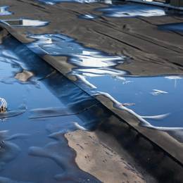 A puddle of water on the roof of a building.