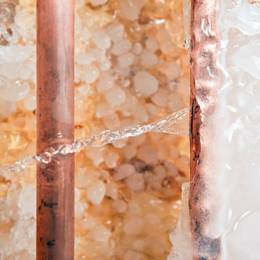 A close up of a pipe with ice on it.