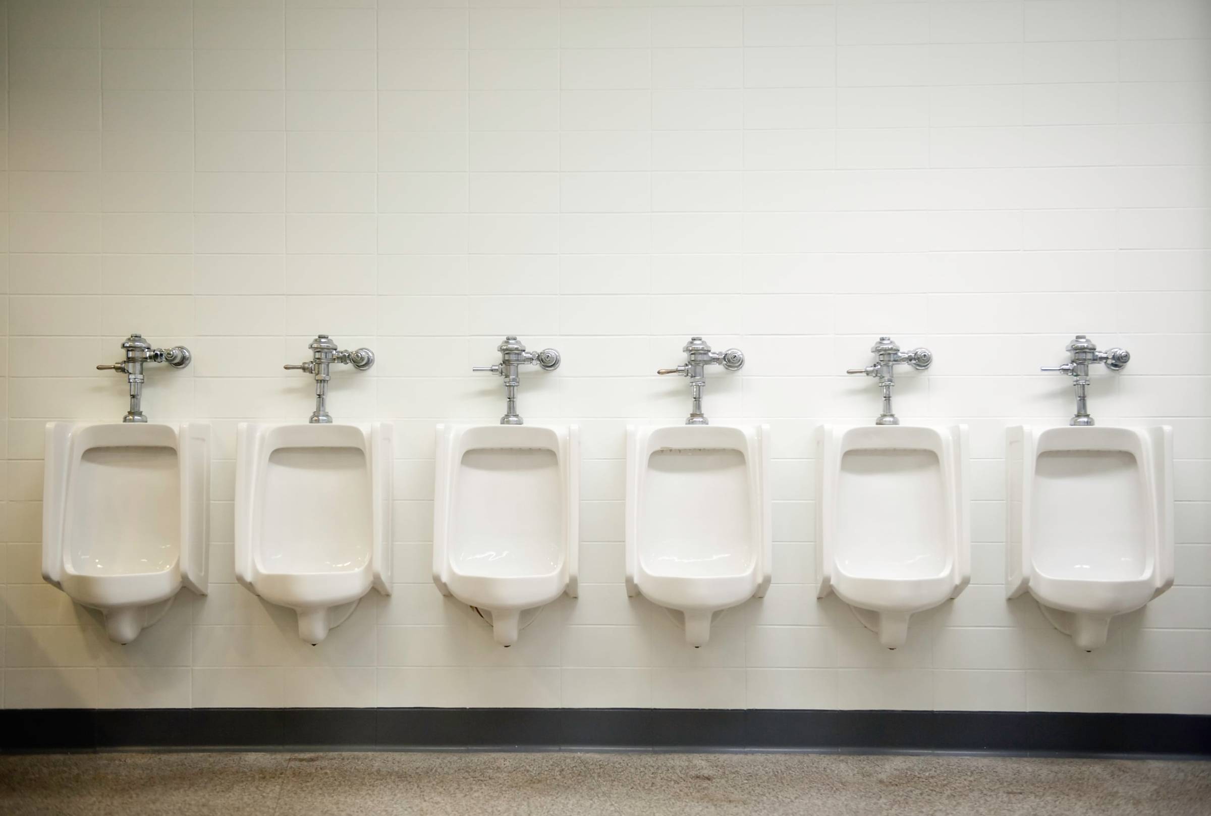 A person is working on a toilet.