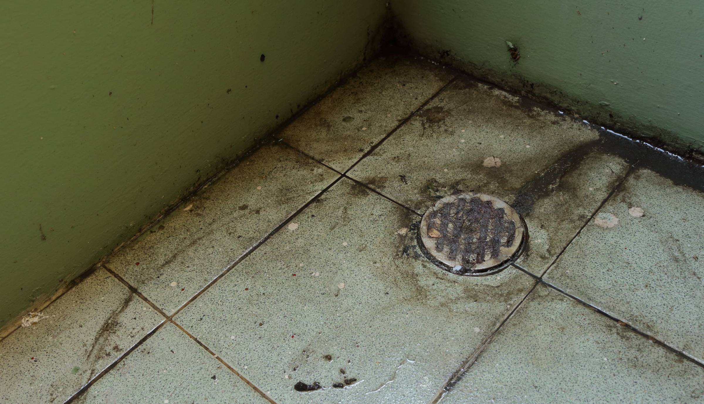 A dirty floor in a bathroom.