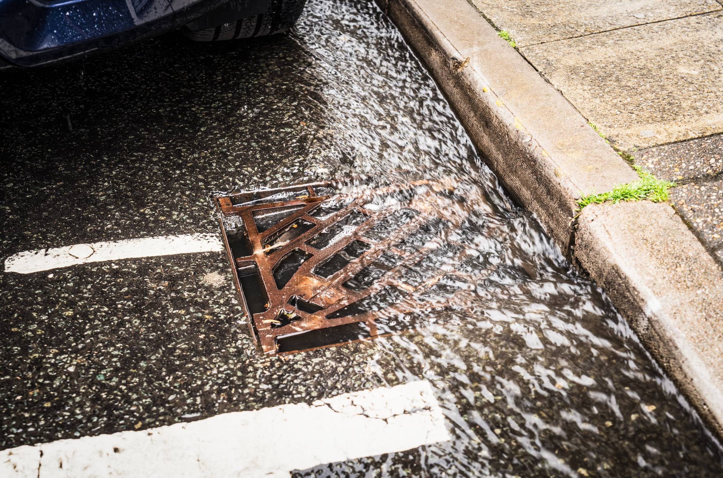 A grate with water dripping from it.