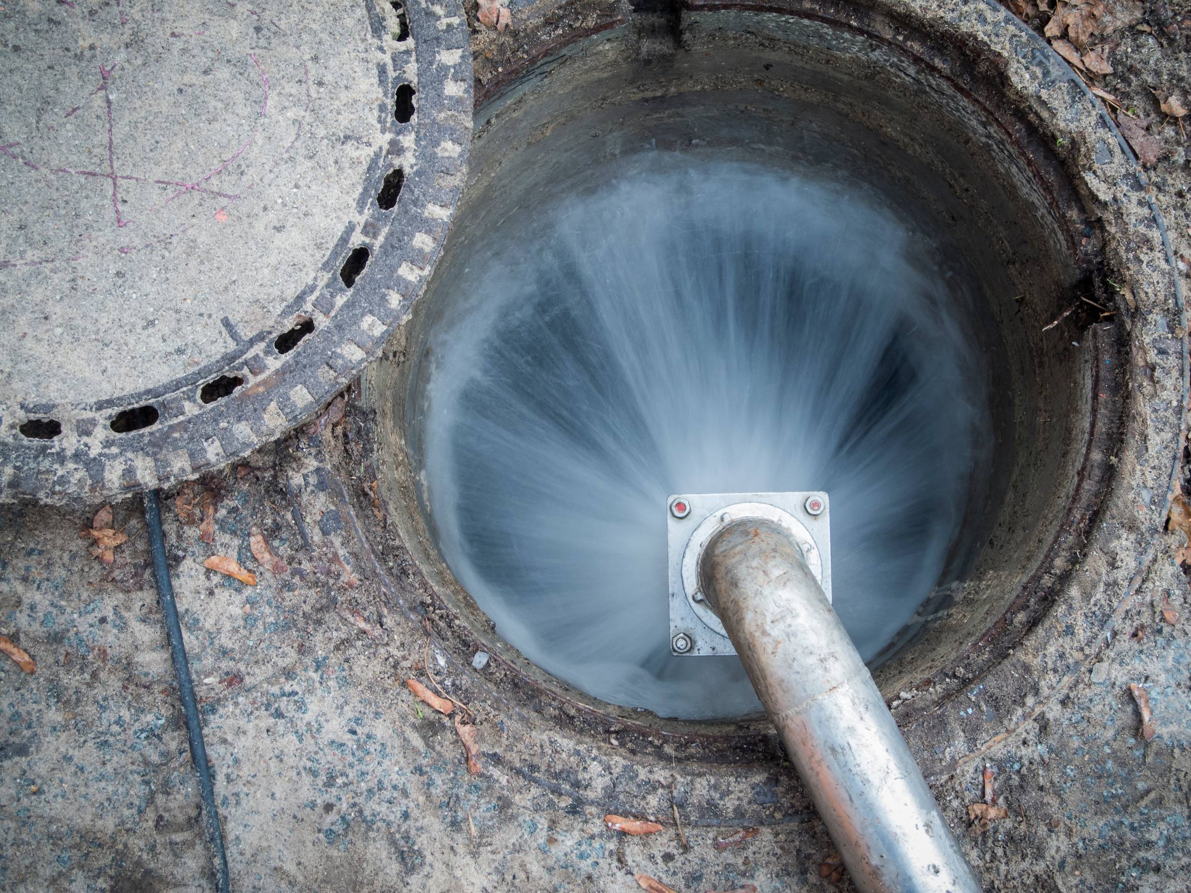 A pipe with water coming out of it.